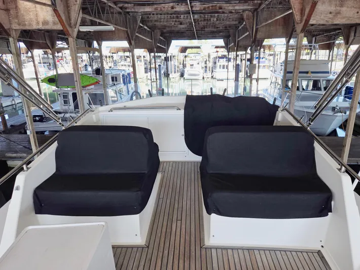 Carina Yacht Photos Pics Covered seating area on a 1990 Grand Banks 36 Europa yacht in a marina.