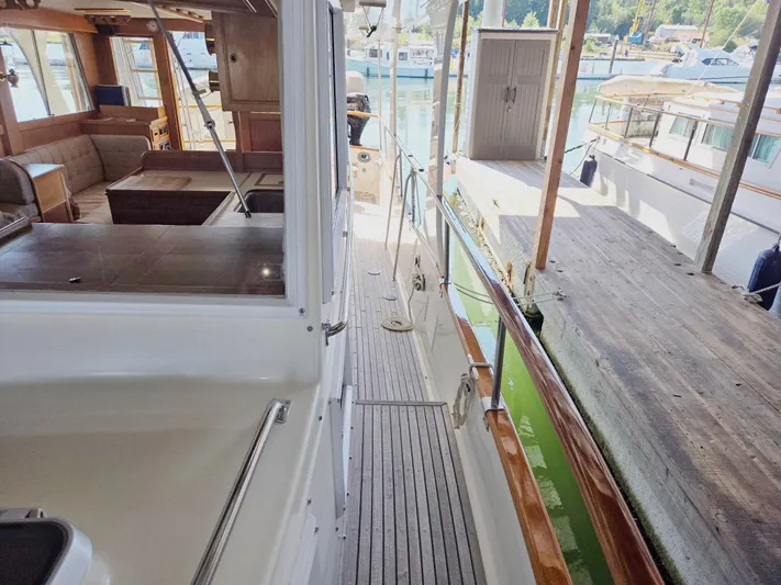 Carina Yacht Photos Pics 1990 Grand Banks 36 Europa yacht interior and deck, docked at marina.