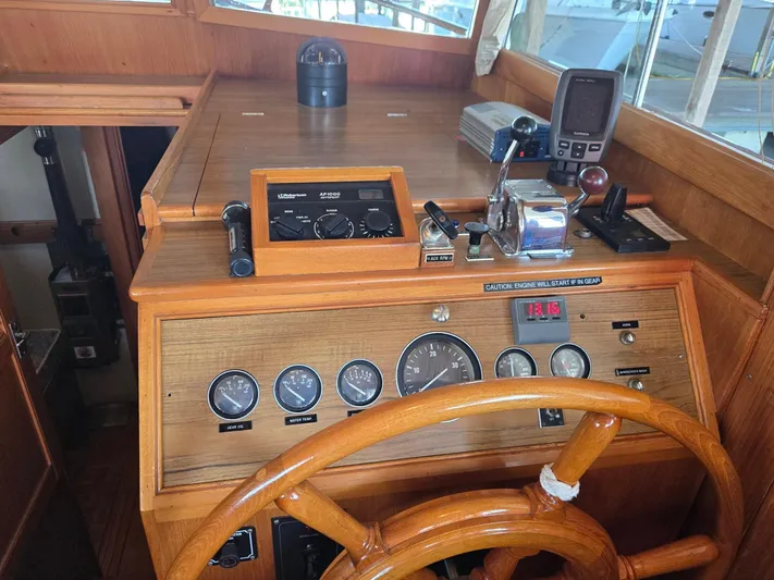 Carina Yacht Photos Pics Helm of 1990 Grand Banks 36 Europa with wooden wheel and navigation instruments.