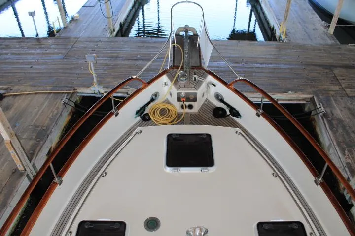 Carina Yacht Photos Pics Bow view of 1990 Grand Banks 36 Europa docked, showcasing deck details and mooring lines.