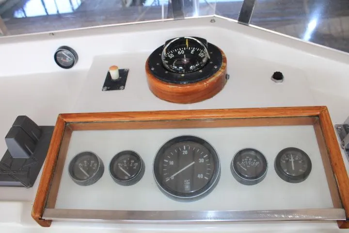 Carina Yacht Photos Pics Control panel of a 1990 Grand Banks 36 Europa boat with gauges and compass.