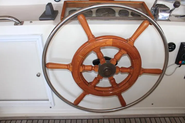Carina Yacht Photos Pics Wooden steering wheel on a 1990 Grand Banks 36 Europa yacht.