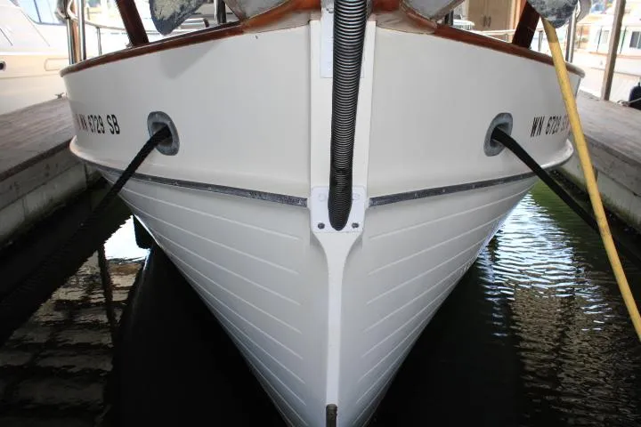 Carina Yacht Photos Pics Front view of a 1990 Grand Banks 36 Europa boat docked in water.
