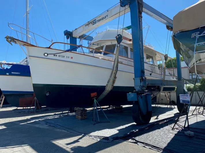 Carina Yacht Photos Pics 1990 Grand Banks 36 Europa yacht in dry dock, supported by a marine travel lift.