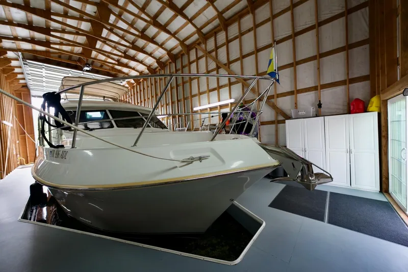 Nautilus Yacht Photos Pics 2008 Navigator 5100 yacht docked in a spacious wooden boathouse.