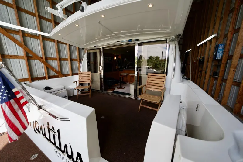 Nautilus Yacht Photos Pics 2008 Navigator 5100 yacht interior with wooden chairs and American flag.