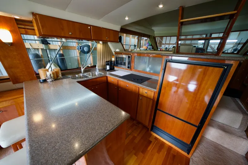 Nautilus Yacht Photos Pics Luxurious 2008 Navigator 5100 yacht kitchen with wood cabinetry and modern appliances.