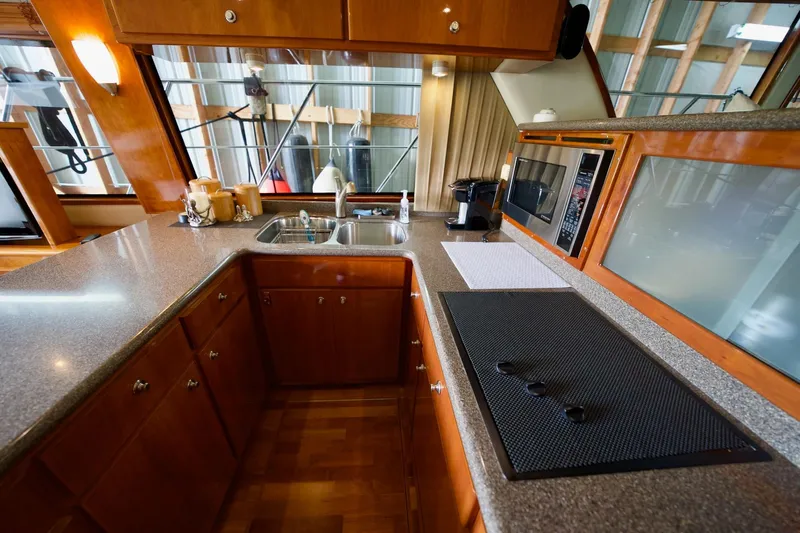 Nautilus Yacht Photos Pics Luxurious kitchen interior of 2008 Navigator 5100 yacht with modern appliances and wooden cabinetry.