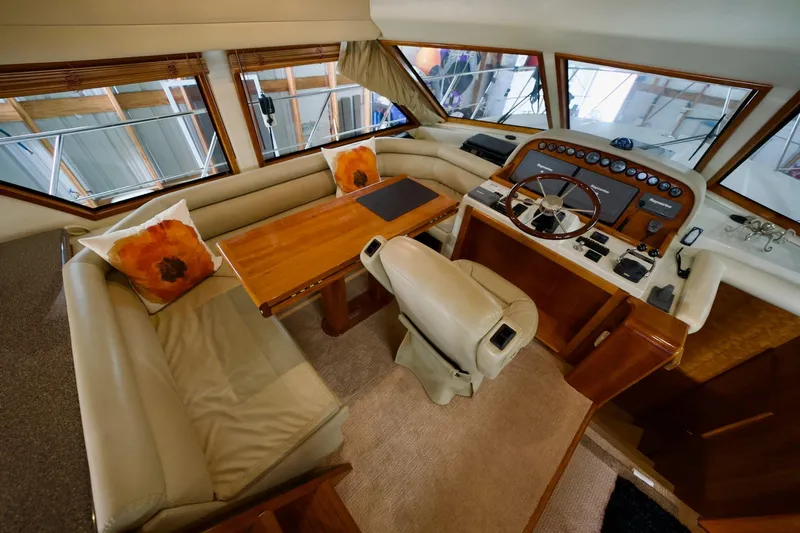 Nautilus Yacht Photos Pics Luxurious 2008 Navigator 5100 yacht interior with helm, seating, and wooden table.