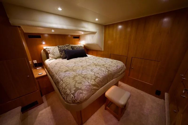 Nautilus Yacht Photos Pics Luxurious bedroom interior of 2008 Navigator 5100 yacht with elegant bedding and warm lighting.