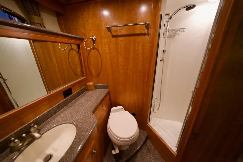Nautilus Yacht Photos Pics Luxurious 2008 Navigator 5100 yacht bathroom with wood accents, shower, and vanity.