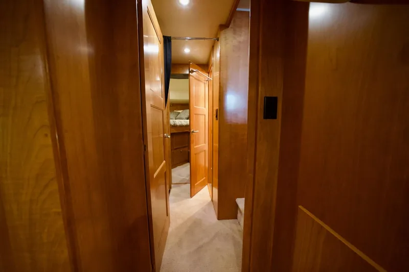 Nautilus Yacht Photos Pics Interior hallway of 2008 Navigator 5100 yacht with wooden paneling and open doors.