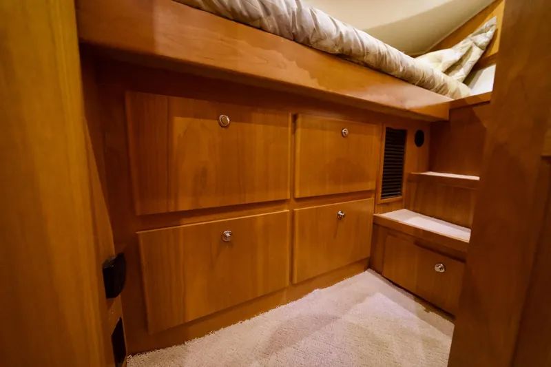 Nautilus Yacht Photos Pics Interior of 2008 Navigator 5100 yacht with wooden cabinetry and carpeted flooring.