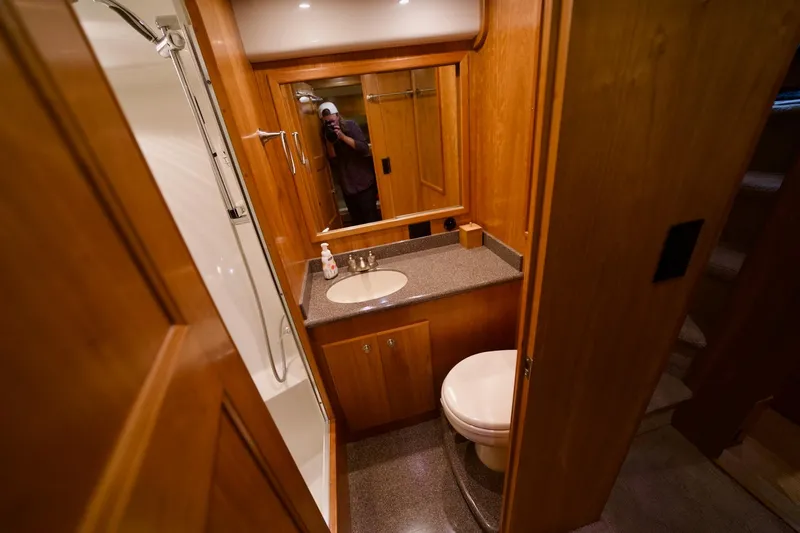 Nautilus Yacht Photos Pics Luxurious bathroom in 2008 Navigator 5100 yacht with wooden cabinetry and modern fixtures.