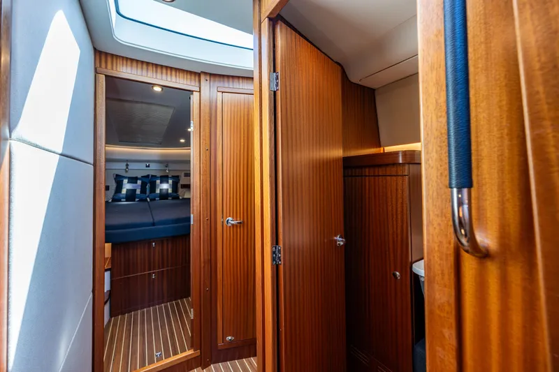  Yacht Photos Pics Interior of 2021 Nimbus 405 Coupé #88, featuring wooden cabinetry and cozy cabin space.