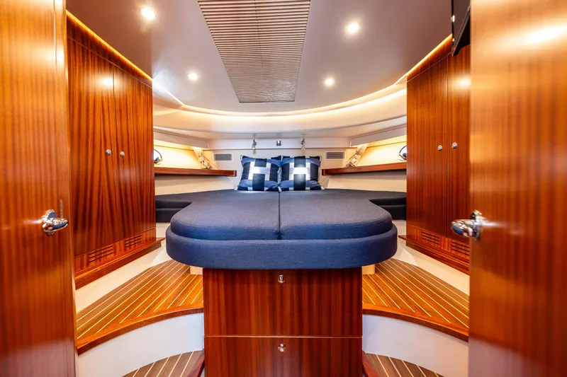  Yacht Photos Pics Luxurious interior of 2021 Nimbus 405 Coupé yacht with elegant wood finish and cozy bedding.