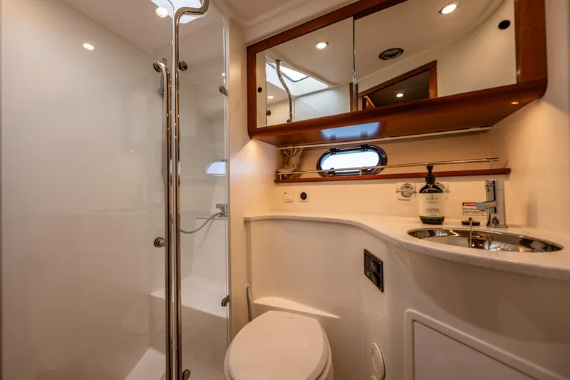  Yacht Photos Pics Luxurious bathroom in 2021 Nimbus 405 Coupé yacht, featuring modern fixtures and elegant design.