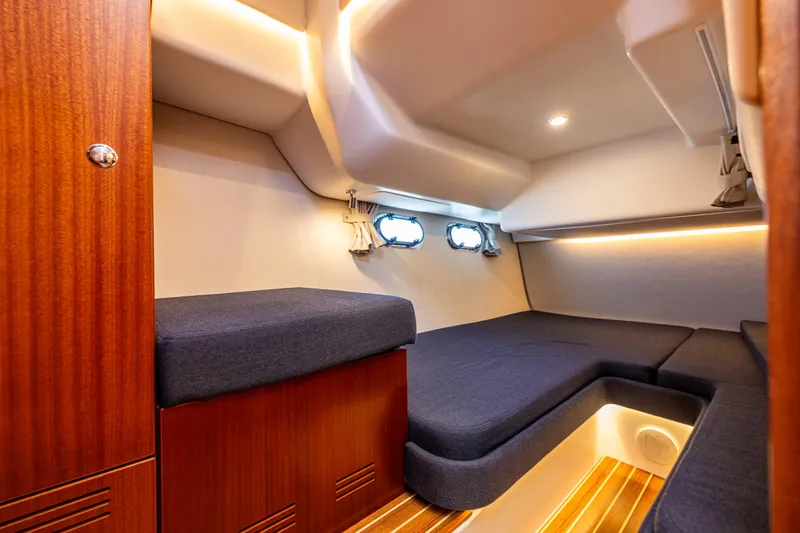  Yacht Photos Pics Luxurious interior cabin of 2021 Nimbus 405 Coupé yacht with wooden accents and cozy seating.