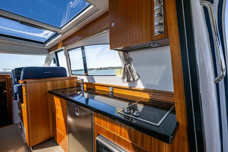  Yacht Photos Pics Luxurious interior of 2021 Nimbus 405 Coupé yacht with modern kitchen and panoramic windows.