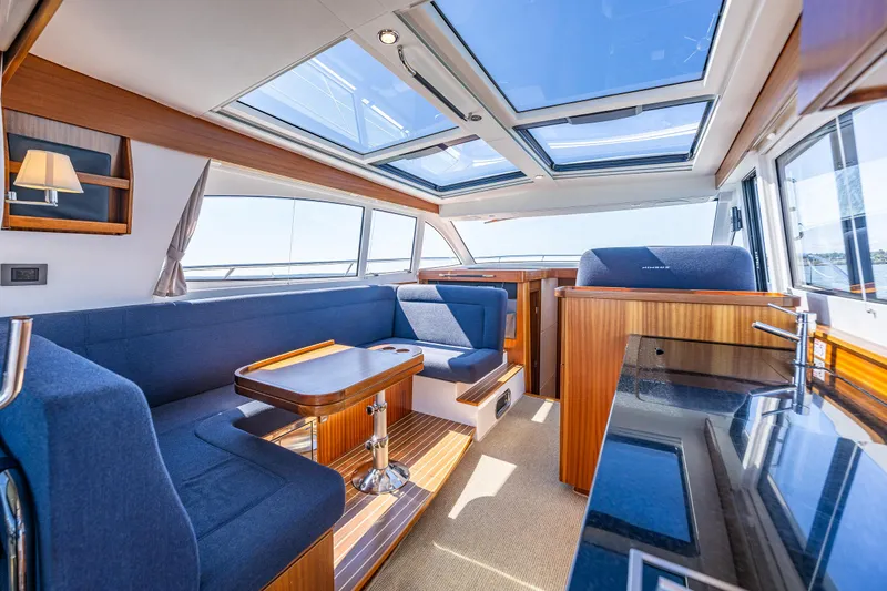  Yacht Photos Pics Luxurious interior of 2021 Nimbus 405 Coupé yacht with skylights and elegant seating.