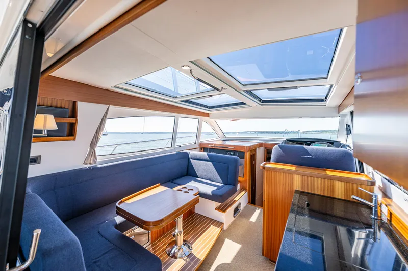  Yacht Photos Pics Luxurious interior of 2021 Nimbus 405 Coupé yacht with skylights and elegant seating.