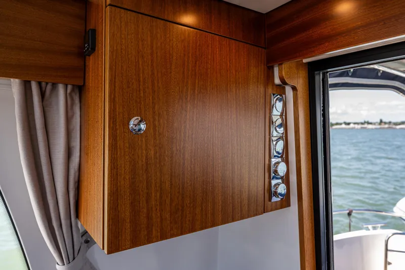  Yacht Photos Pics Wooden cabinet and chrome details inside a 2021 Nimbus 405 Coupé yacht, with ocean view.