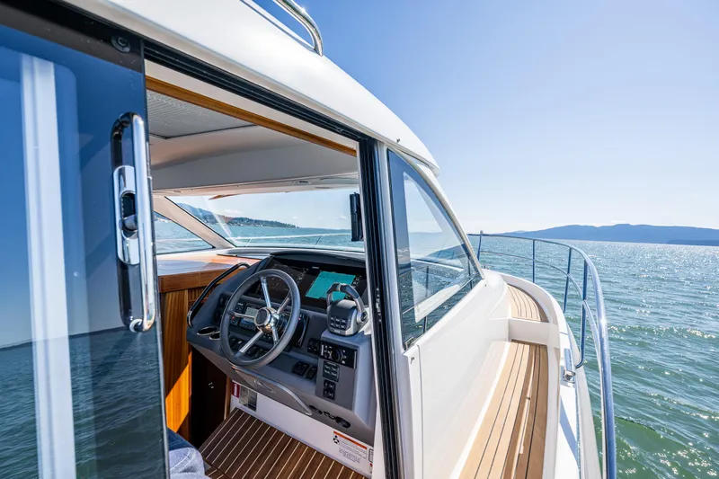  Yacht Photos Pics 2021 Nimbus 405 Coupé #88 yacht interior with steering wheel, cruising on open water.