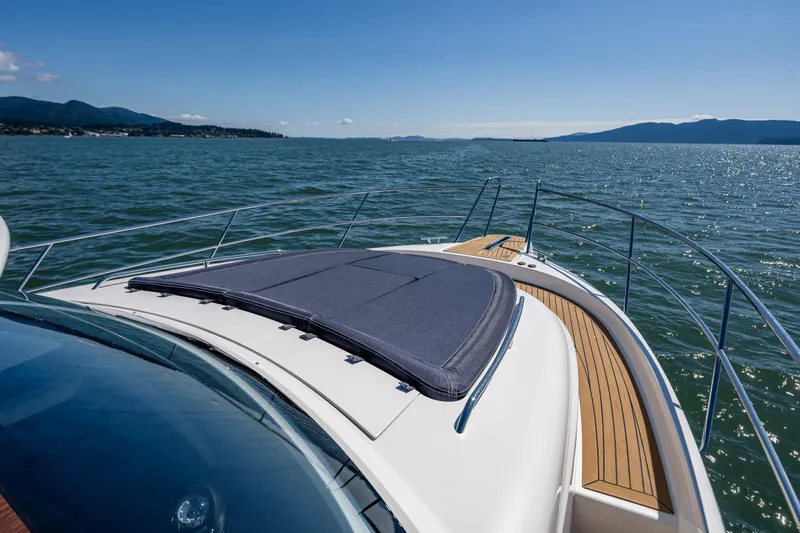  Yacht Photos Pics Nimbus 405 Coupé #88, 2021 model, cruising on a serene lake with scenic mountain views.