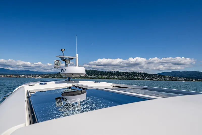  Yacht Photos Pics Nimbus 405 Coupé #88, 2021 model, cruising on a serene lake with scenic mountain backdrop.