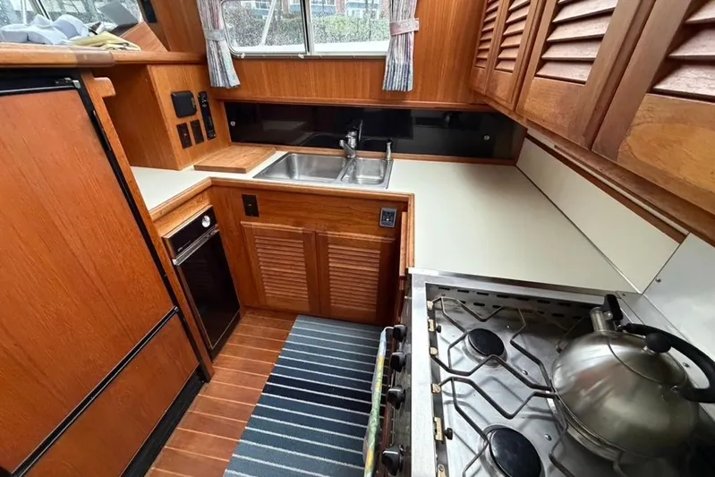 "sarona Ii" Yacht Photos Pics 1994 Tollycraft 45 Cockpit Motor Yacht kitchen with wood cabinetry and stainless steel appliances.