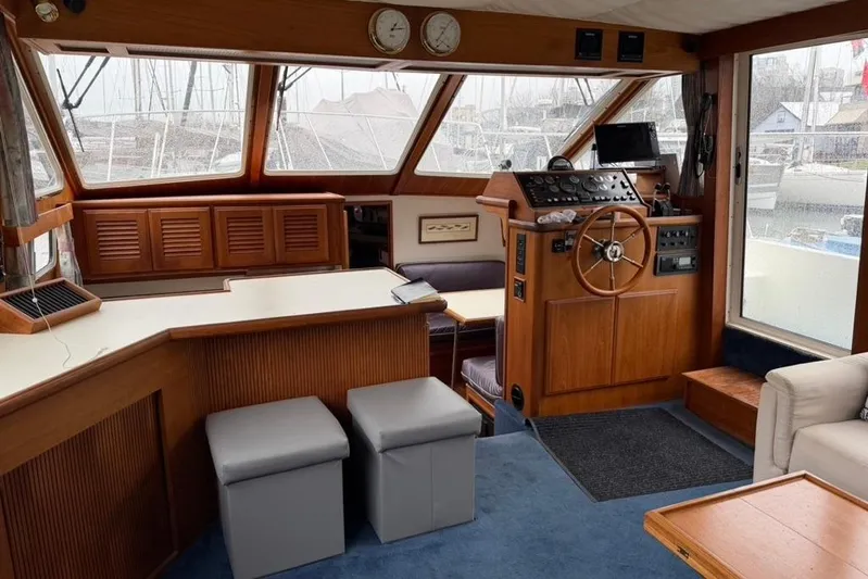 "sarona Ii" Yacht Photos Pics Interior of 1994 Tollycraft 45 Cockpit Motor Yacht with wooden helm and seating area.