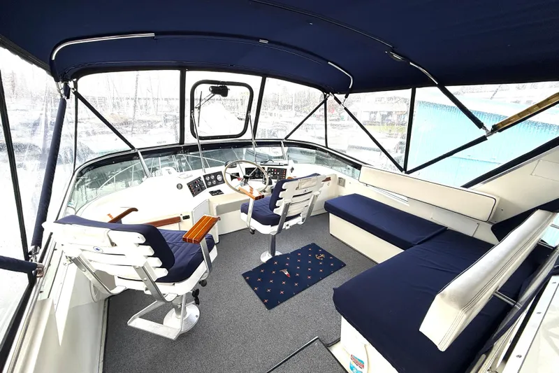 "sarona Ii" Yacht Photos Pics 1994 Tollycraft 45 Cockpit Motor Yacht interior with blue seating and helm station.
