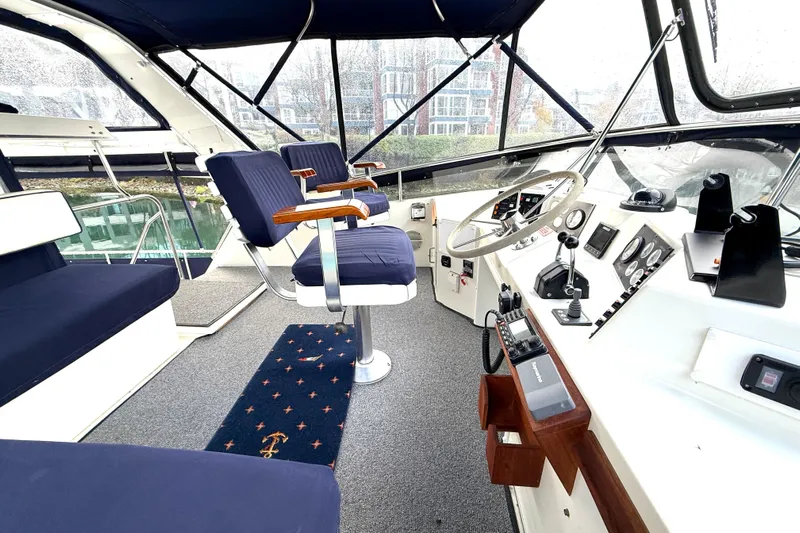 "sarona Ii" Yacht Photos Pics Interior of 1994 Tollycraft 45 Cockpit Motor Yacht with blue seating and control panel.