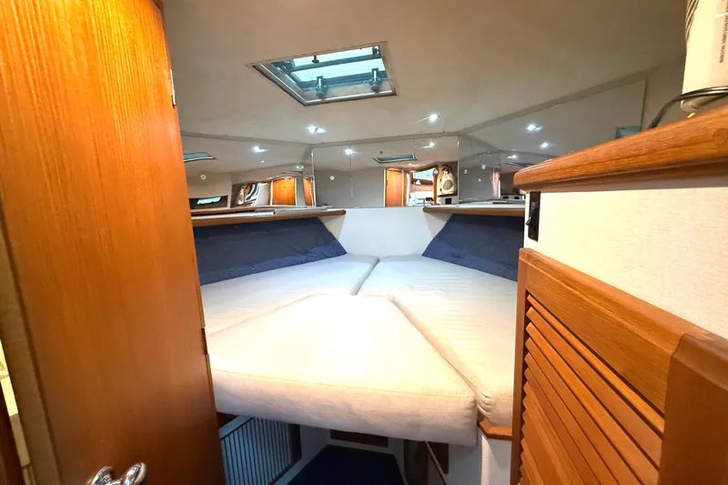 "sarona Ii" Yacht Photos Pics Interior cabin of 1994 Tollycraft 45 Cockpit Motor Yacht with cozy bedding.