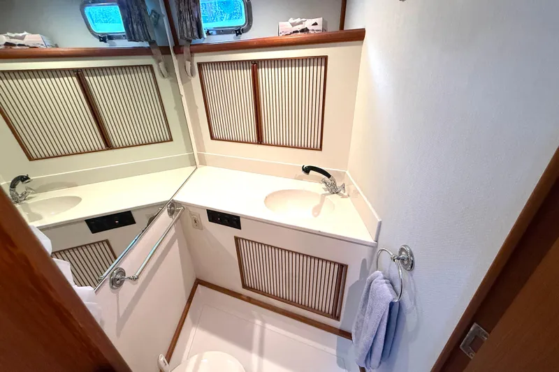 "sarona Ii" Yacht Photos Pics Bathroom interior of 1994 Tollycraft 45 Cockpit Motor Yacht, featuring sink and mirror.