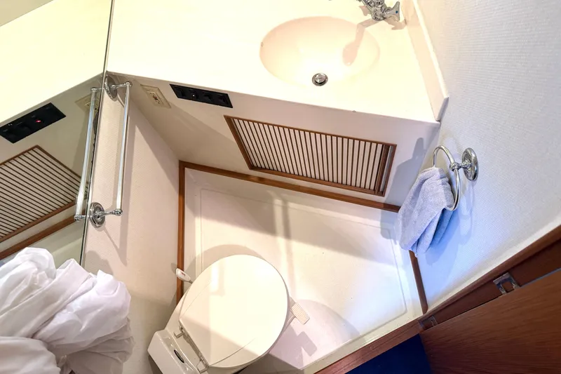 "sarona Ii" Yacht Photos Pics Bathroom interior of 1994 Tollycraft 45 Cockpit Motor Yacht with sink and toilet.