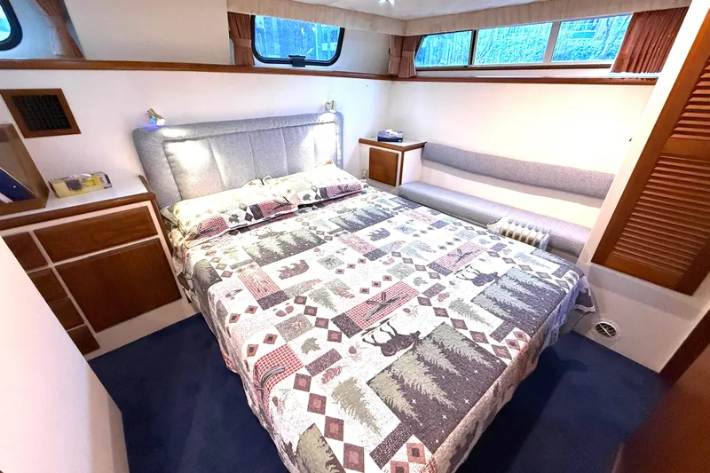 "sarona Ii" Yacht Photos Pics Luxurious bedroom in 1994 Tollycraft 45 Cockpit Motor Yacht with patterned bedding.