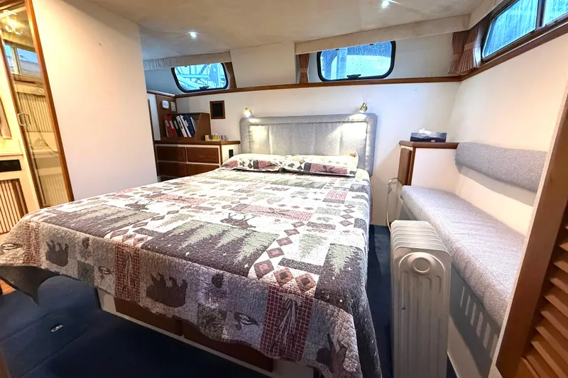 "sarona Ii" Yacht Photos Pics Cozy bedroom in 1994 Tollycraft 45 Cockpit Motor Yacht with quilted bedspread and ample storage.