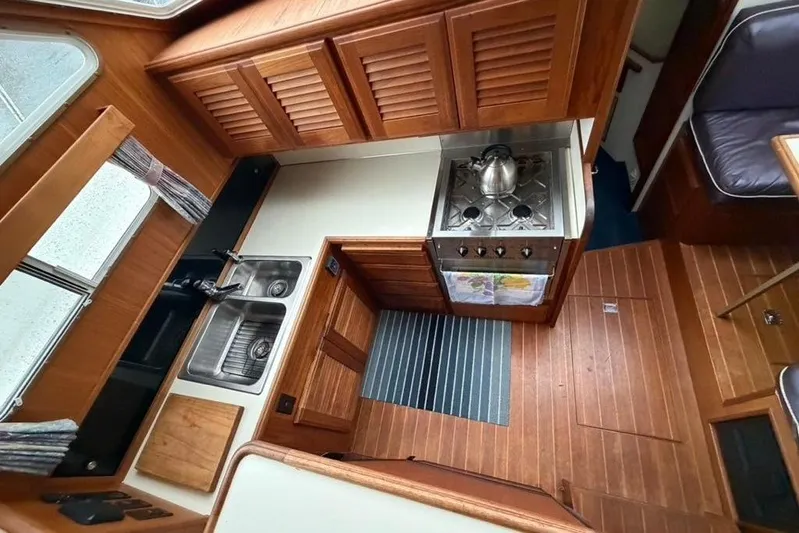 "sarona Ii" Yacht Photos Pics 1994 Tollycraft 45 Cockpit Motor Yacht interior kitchen with wood cabinetry and modern appliances.