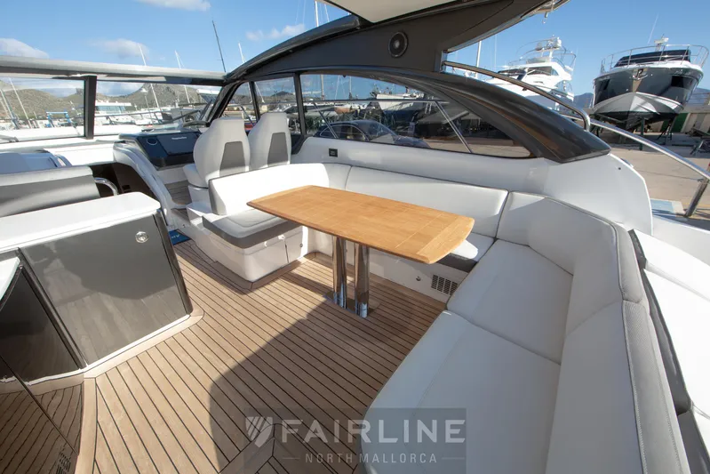  Yacht Photos Pics Luxurious 2017 Princess V48 Open yacht interior with elegant seating and wooden table.