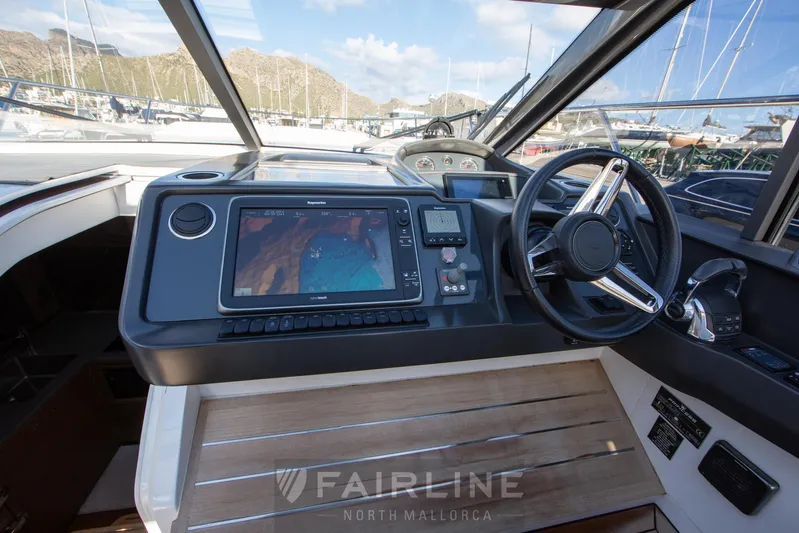  Yacht Photos Pics 2017 Princess V48 Open yacht helm with navigation system and steering wheel.