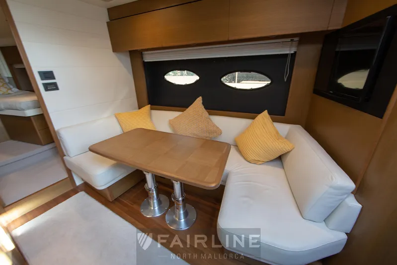  Yacht Photos Pics Luxurious interior of 2017 Princess V48 Open yacht with cozy seating and elegant table.