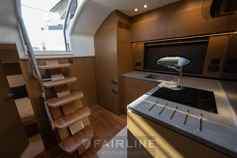  Yacht Photos Pics Luxurious interior of 2017 Princess V48 Open yacht with modern kitchen and wooden stairs.