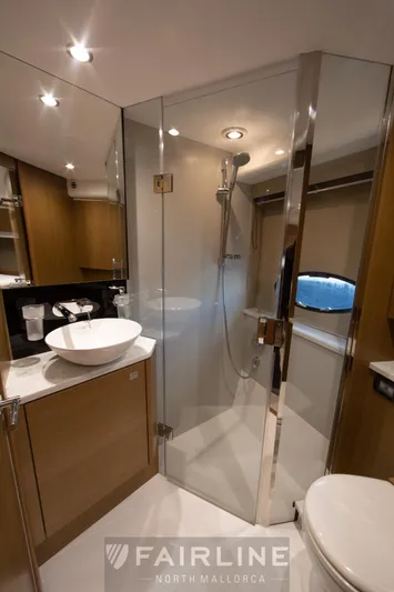 Yacht Photos Pics Luxurious bathroom in 2017 Princess V48 Open yacht with modern fixtures and glass shower.