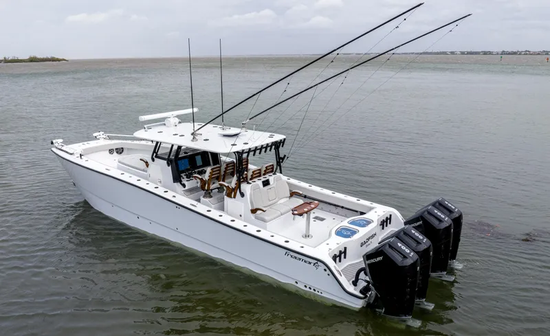  Yacht Photos Pics 2024 Freeman 42 LR boat with multiple outboard engines on calm water.