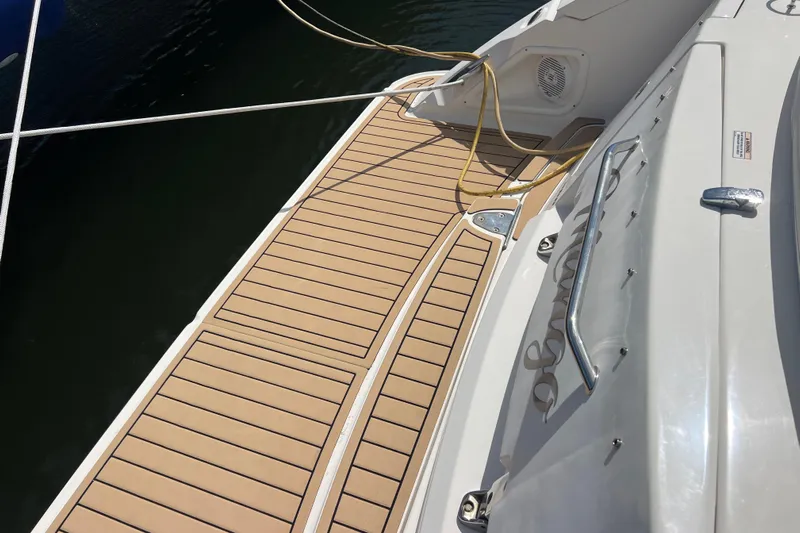 Mango Yacht Photos Pics 2005 Sea Ray Sundancer 350 boat deck with teak flooring and mooring lines.
