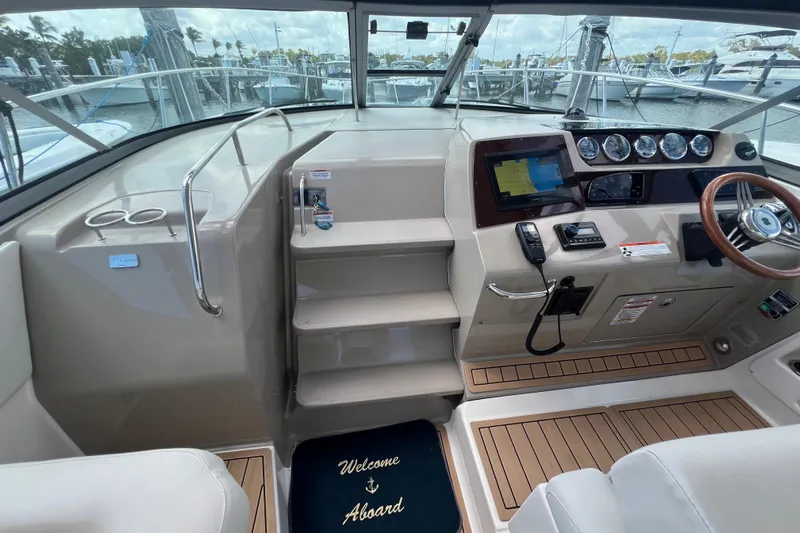 Mango Yacht Photos Pics 2005 Sea Ray Sundancer 350 helm with navigation equipment and welcome mat.