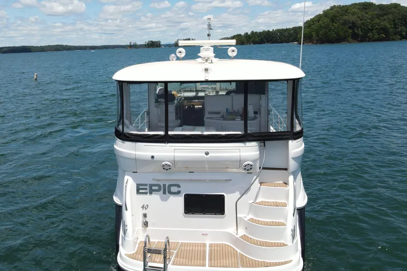  Yacht Photos Pics 2007 Sea Ray 40 Motor Yacht on a serene lake with clear skies.