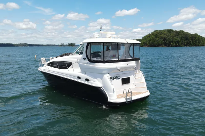  Yacht Photos Pics 2007 Sea Ray 40 Motor Yacht on a serene lake with lush green island backdrop.