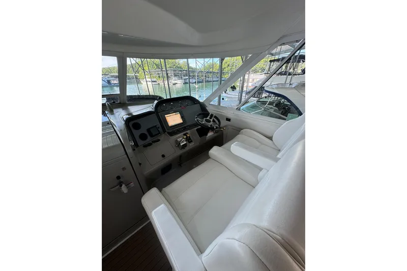  Yacht Photos Pics 2007 Sea Ray 40 Motor Yacht helm with white seating and navigation controls.